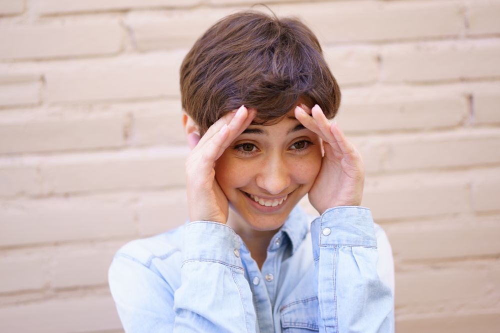 A Joyful Young Person Expressing Genuine Surprise and Delight in a Vibrant Setting