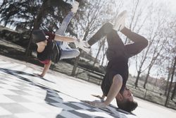 Young men dancing break dance in park