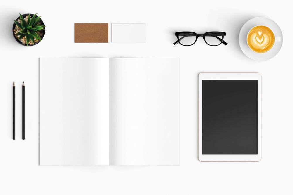 Modern workspace with coffee cup, smartphone, paper, notebook, tablet copy space