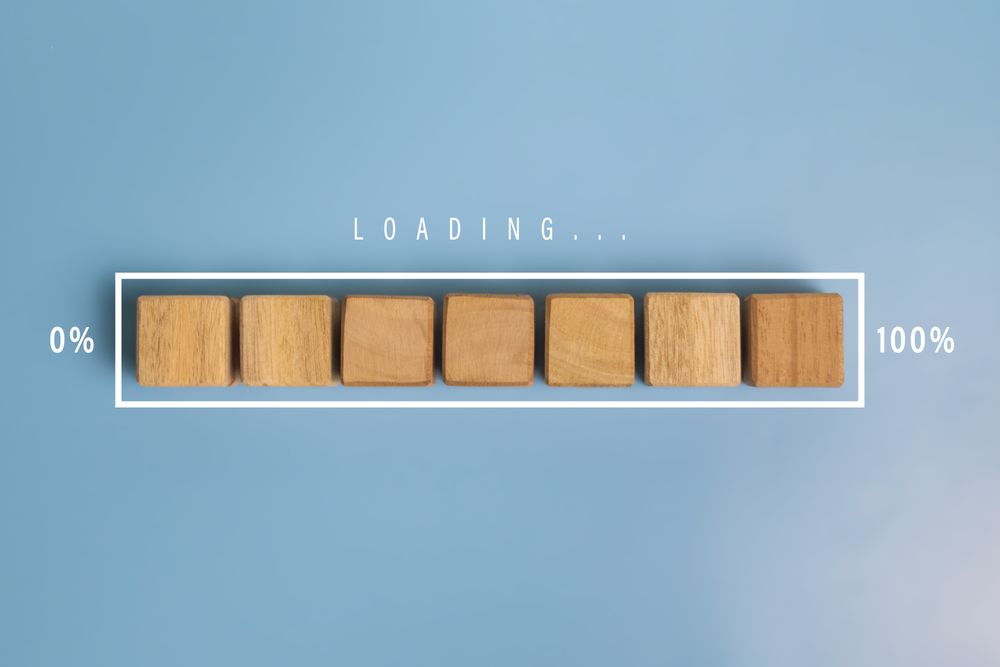 loading word with wooden blocks and white bar progress isolated on light blue background