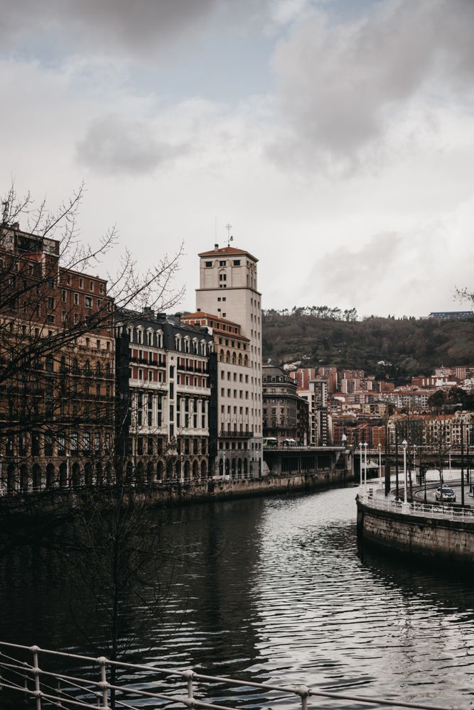 Cloudy sky over buildings and channel