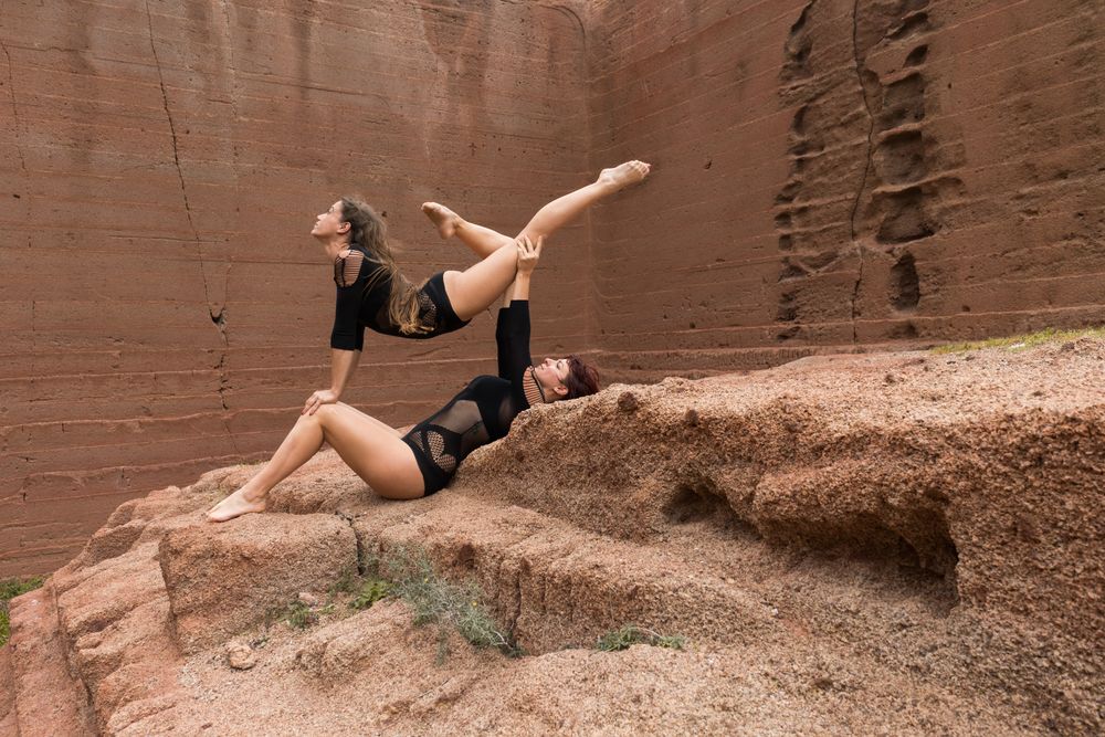 Young women exercising on stones