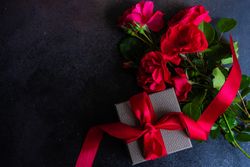 Top view of red roses and present