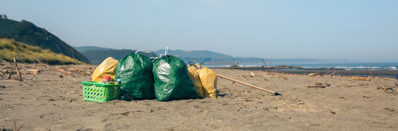 Garbage bags and utensils on the beach