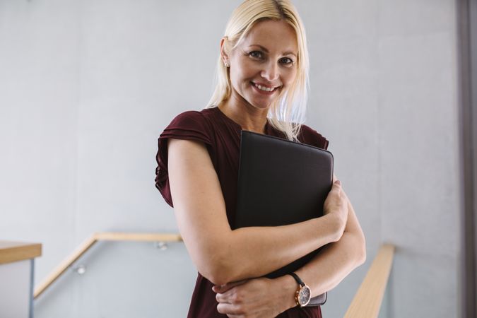Businesswoman standing in the office holding file