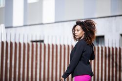Black female turning around outside with her face to the sun