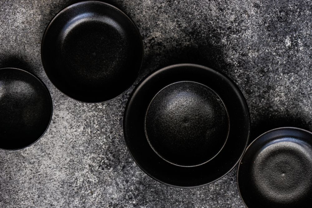 Round geometric dark bowls on counter