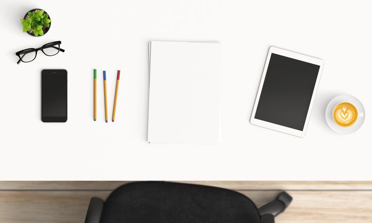 Modern workplace with coffee cup and smartphone or laptop copy space on office table background. Top view. Flat lay style