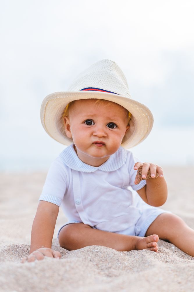 Baby on the beach with hat