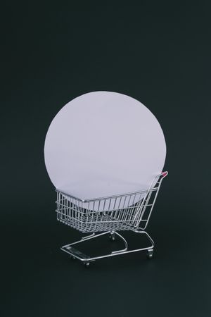 Shopping cart with circular box on dark background