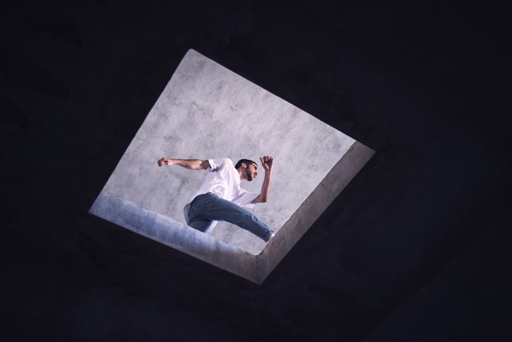 Anonymous man dancing near floor opening
