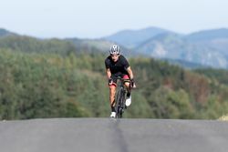 Professional cyclist riding bike in park