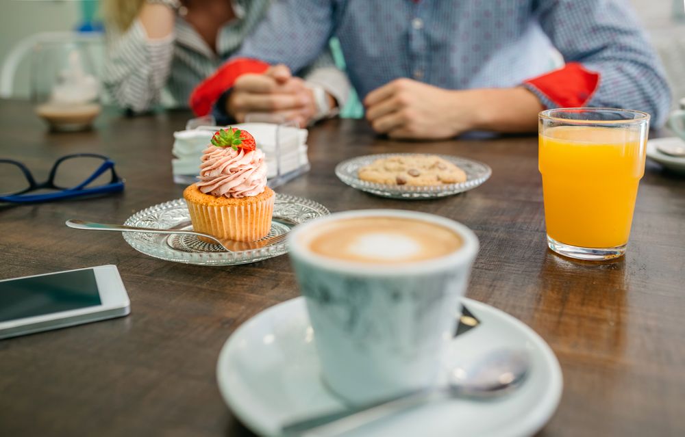 Breakfast with couple holding hands