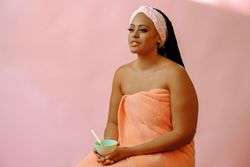 Portrait of woman in spa towel with bowl of product, copy space