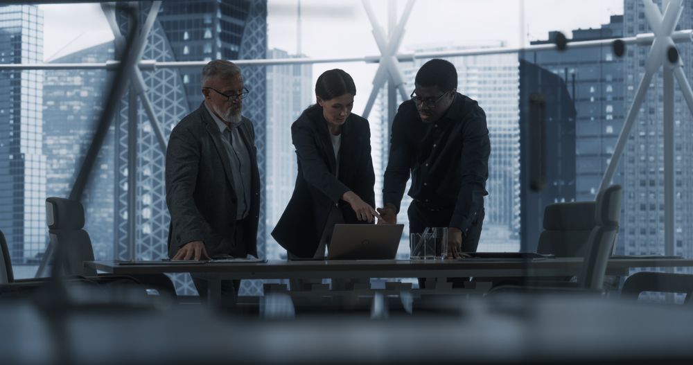 Three Diverse Colleagues Entering Office Meeting Room To Discuss Business Strategy.