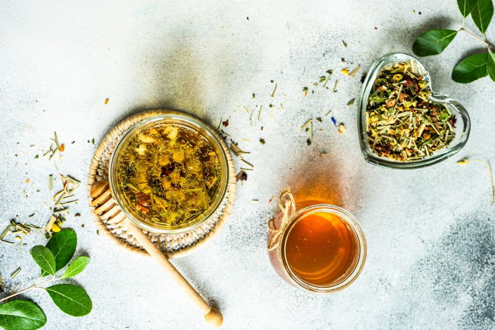 Top view of floral tea with honey and loose leaf tea
