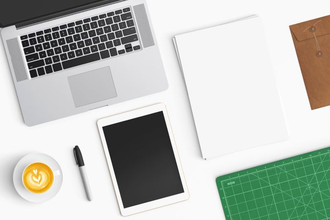 Modern workspace with coffee cup, smartphone, paper, notebook, tablet and laptop copy space