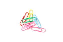 Color paper clips isolated on studio background