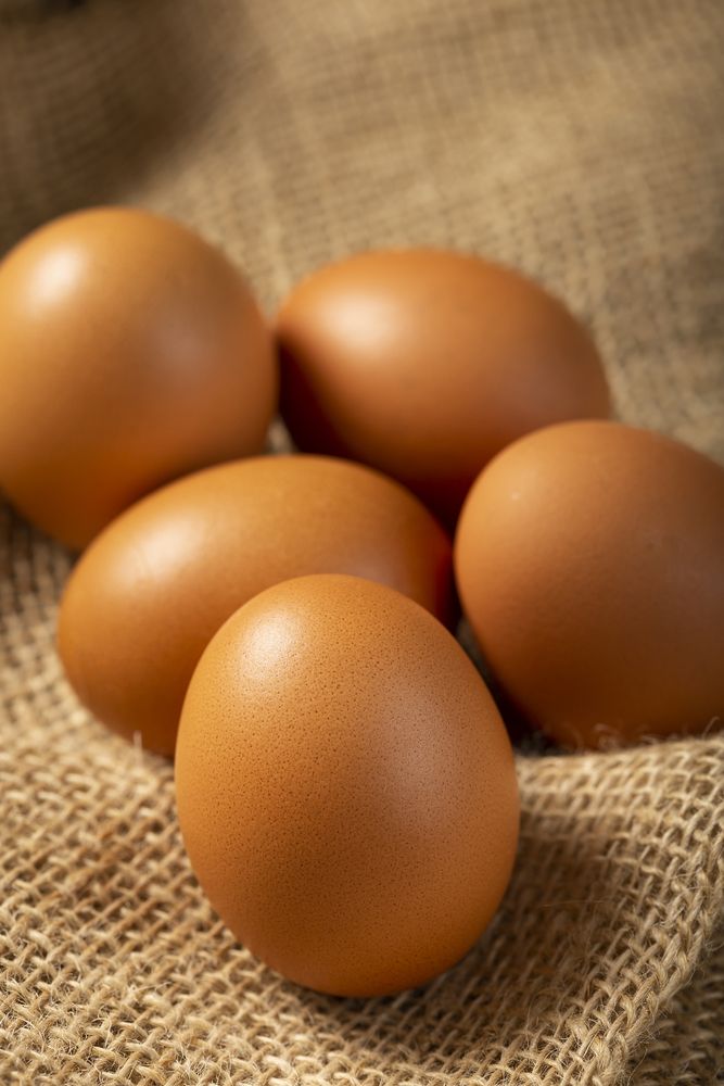 Brown chicken eggs rises on the table.