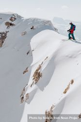 Man standing on top snow-capped mountain 5qQJa5