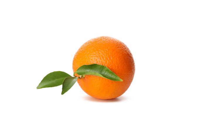 Ripe mandarin with leaves isolated on light background