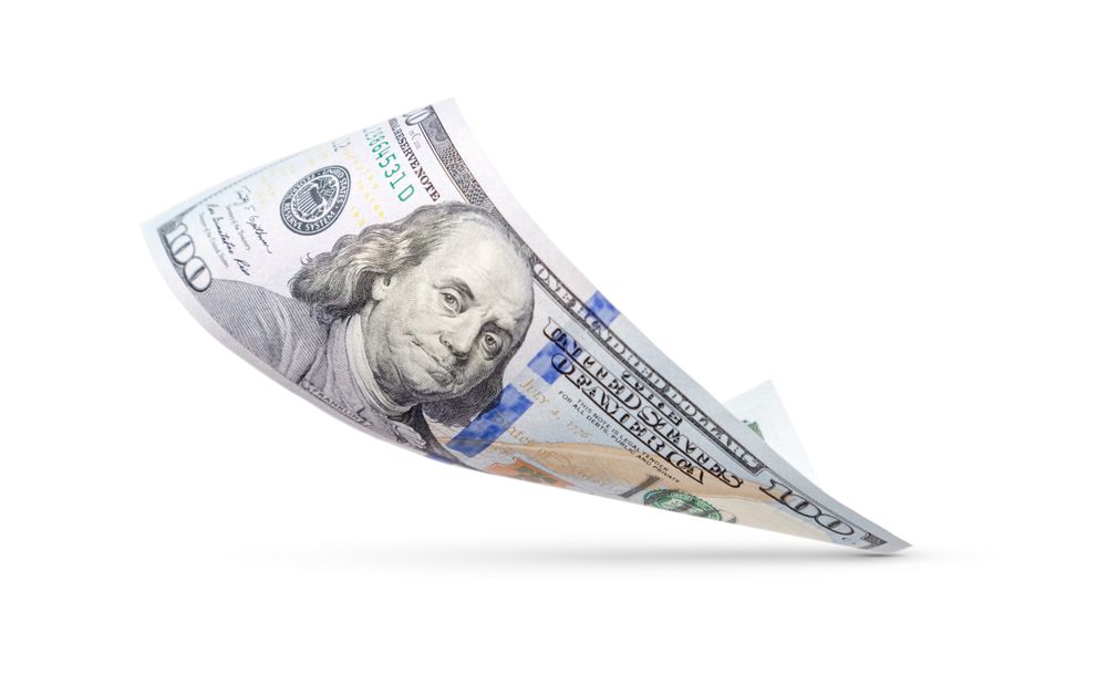 One Hundred Dollar Bill Floating Down To Surface with Drop Shadow