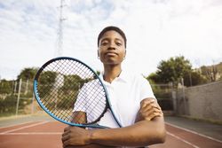 Young women with a racket in a tennis court