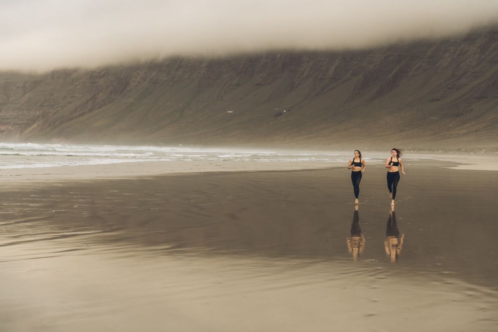Anonymous women running near sea