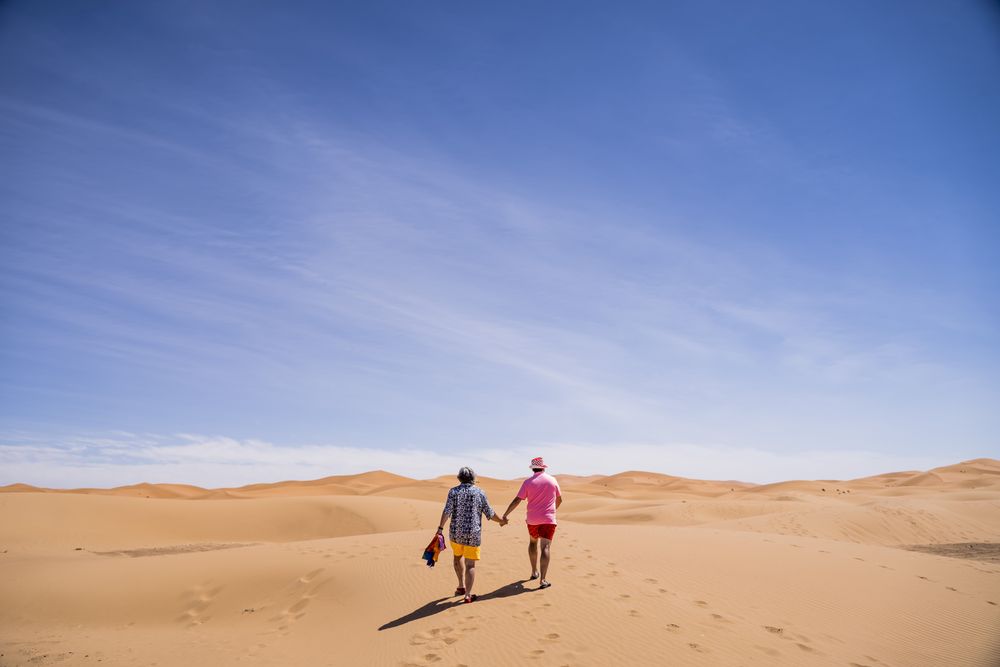 Anonymous gay couple walking in desert