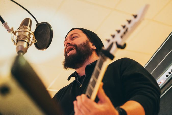 Musician playing guitar and singing