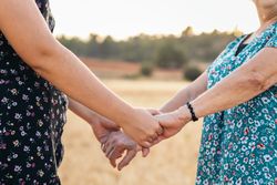 Grandmother And Granddaughter Holding Hands