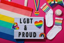 LGBT parade concept, holiday symbols on pink background.