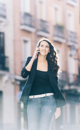 Young female walking with smartphone