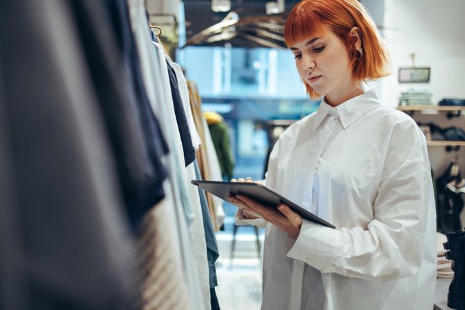 Female entrepreneur using digital tablet in her store