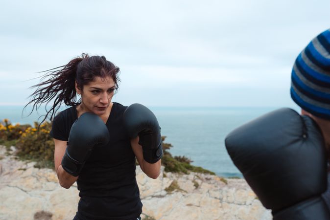 Boxers exercising on cliff