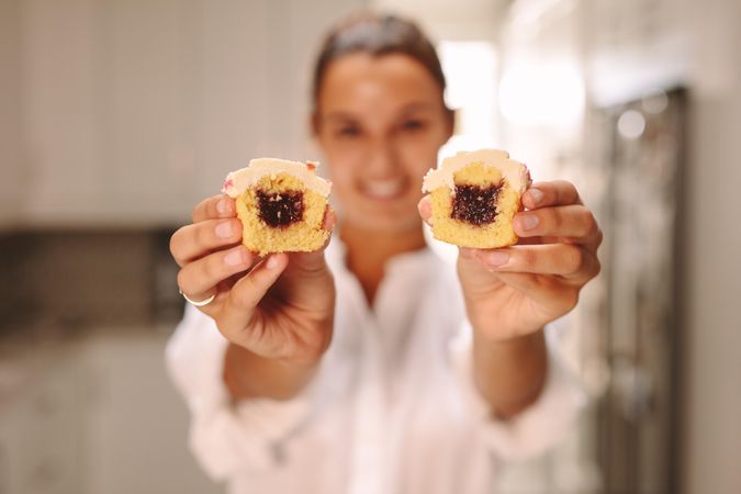 Pastry chef extending arms to show inside of muffin