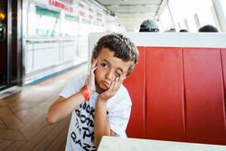 Boy making face with hands on seat
