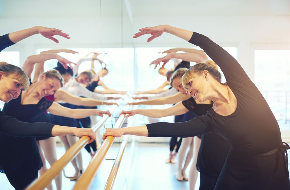 Group of women doing barre workout in dance studio
