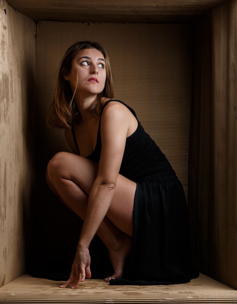 woman sitting in carton box