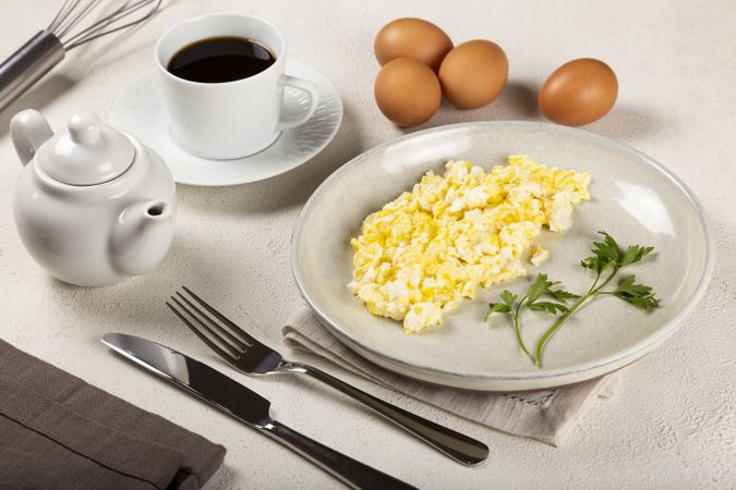 Breakfast with scrambled eggs on the table.