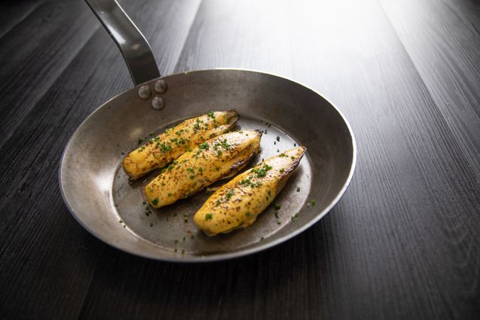 Endives with hollandaise sauce au gratin in pan on table