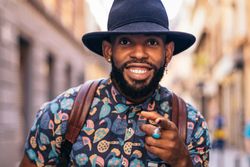 Stylish Black man having fun on the city street