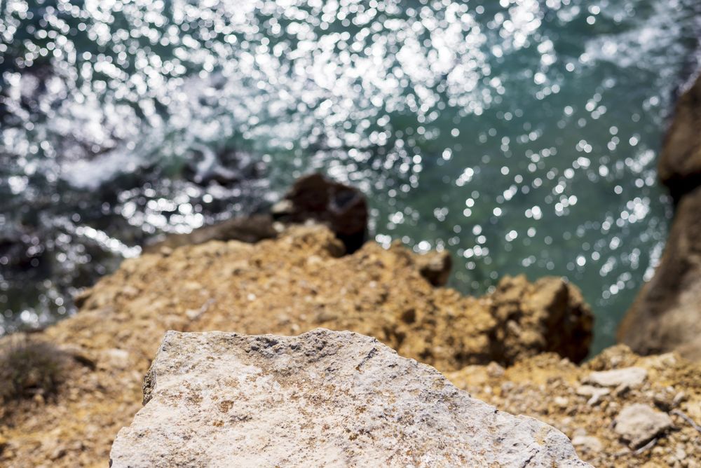Looking down at water from above cliff