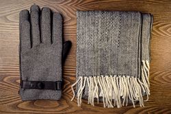 Gloves and scarf on wooden table