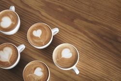 Top view of several cups of cappuccinos