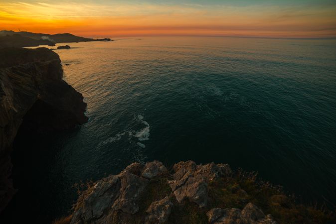Majestic cliffs of ocean coastline in sunset