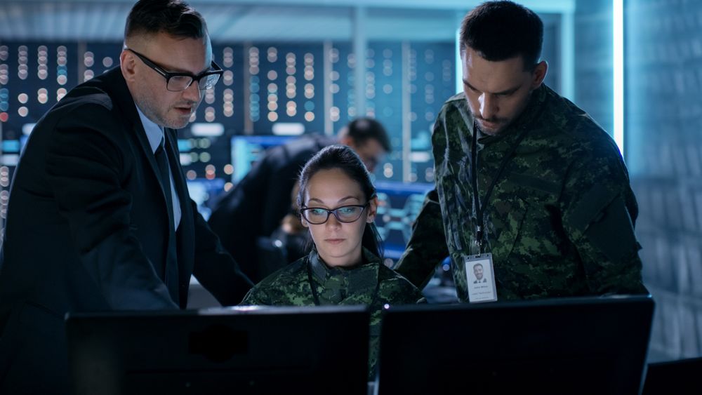 Female and Male Military Officers Working at System Control Center.