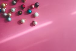 Christmas bauble decoration on shadowy pink background