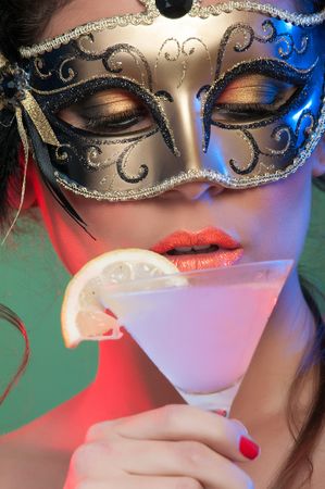 Woman in mask holding glass of drink