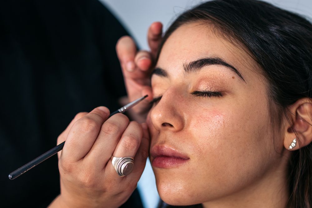 Close-up of a woman having her eyes made up